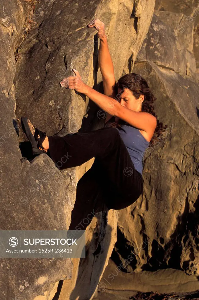 Woman Climbing Rock
