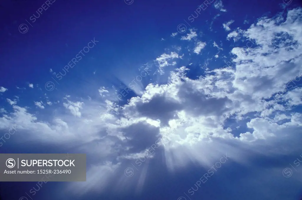 Sunlight Filtered Through Clouds In A Blue Sky