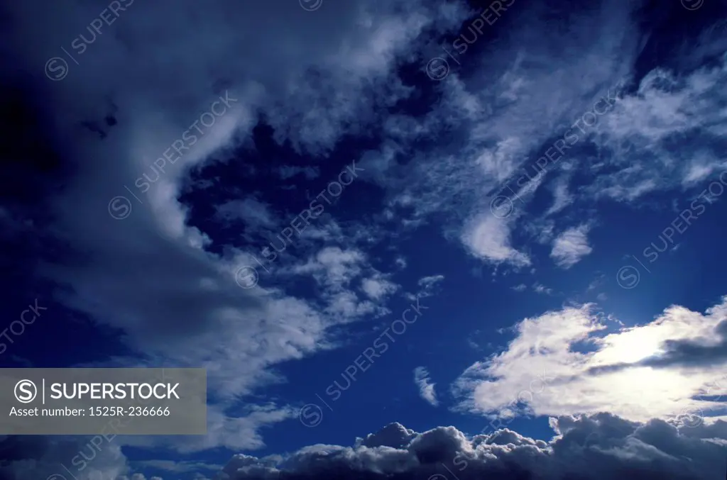 Sunlight Filtered Through Thin Clouds In A Dark Blue Sky