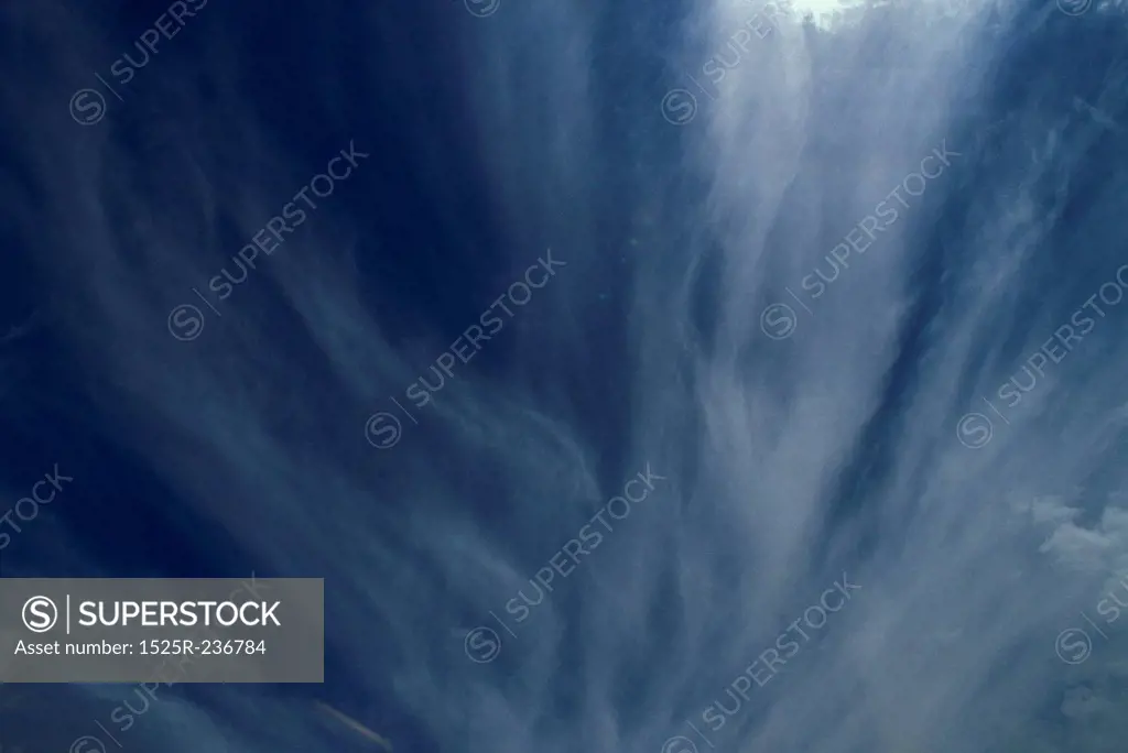 Streaks Of Cloud Wisps In A Dark Blue Sky