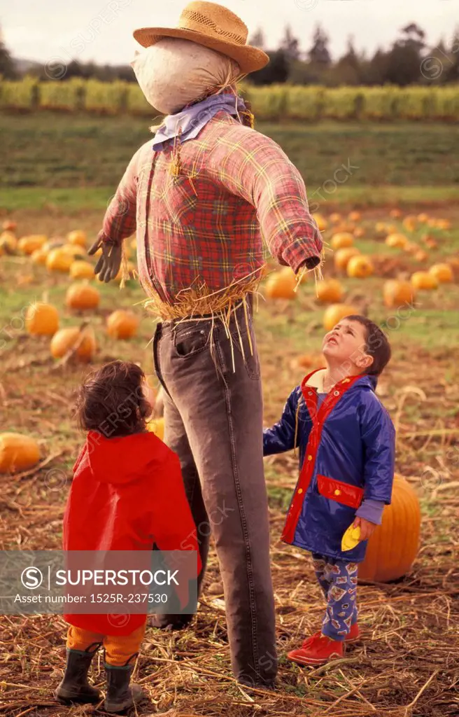 Children Playing with a Scarecrow
