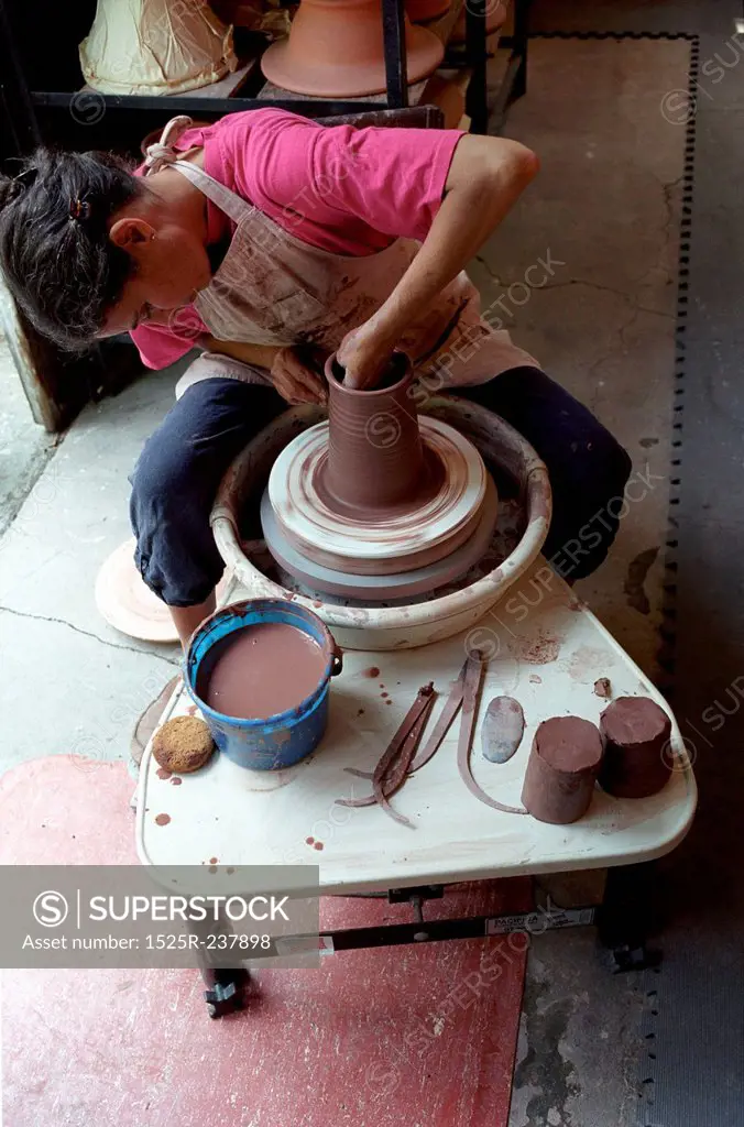 Woman Working At A Pottery Wheel
