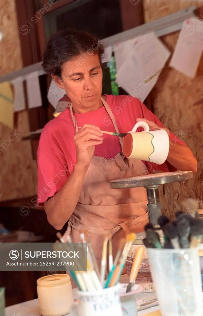 Woman Making A Coffee Mug In Her Pottery Studio