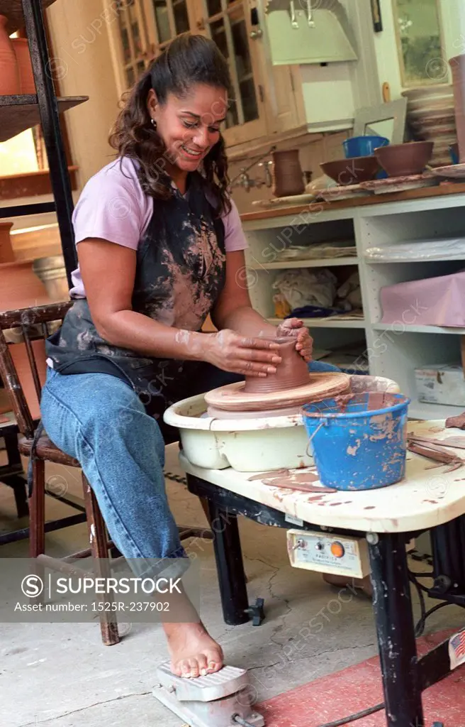 Woman Working At A Pottery Wheel