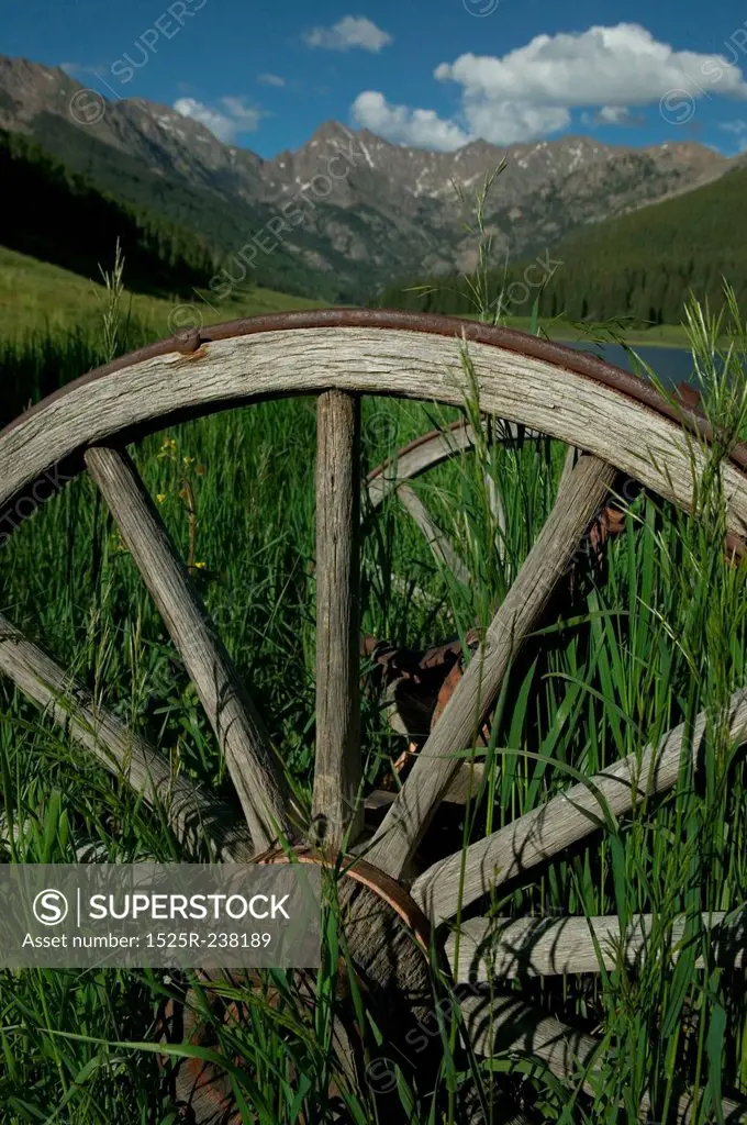 Abandoned Wagon Wheels In A Green Mountain Valley