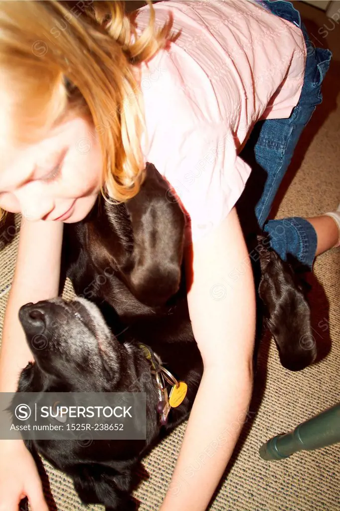 Young Caucasian Girl Wrestling With Her Dog