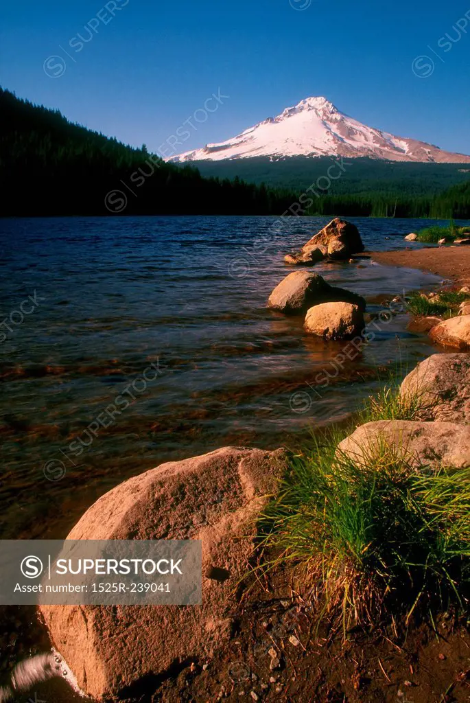 Rocks Lining The Shore Of A Mountain Lake