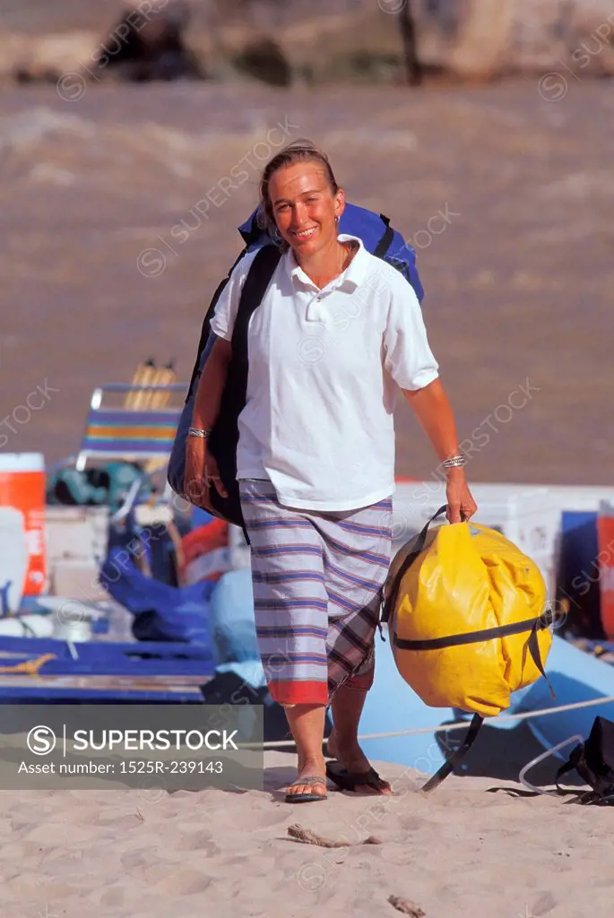 Woman Arriving On Shore After Rafting