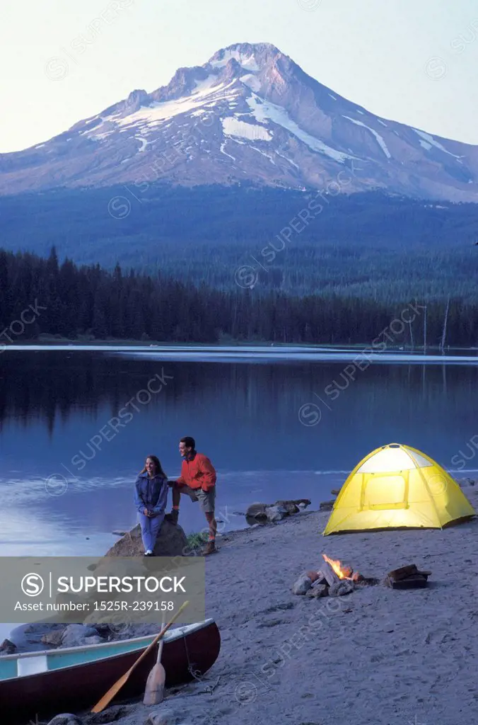 Couple Camping On The Shore Of A Mountain Lake