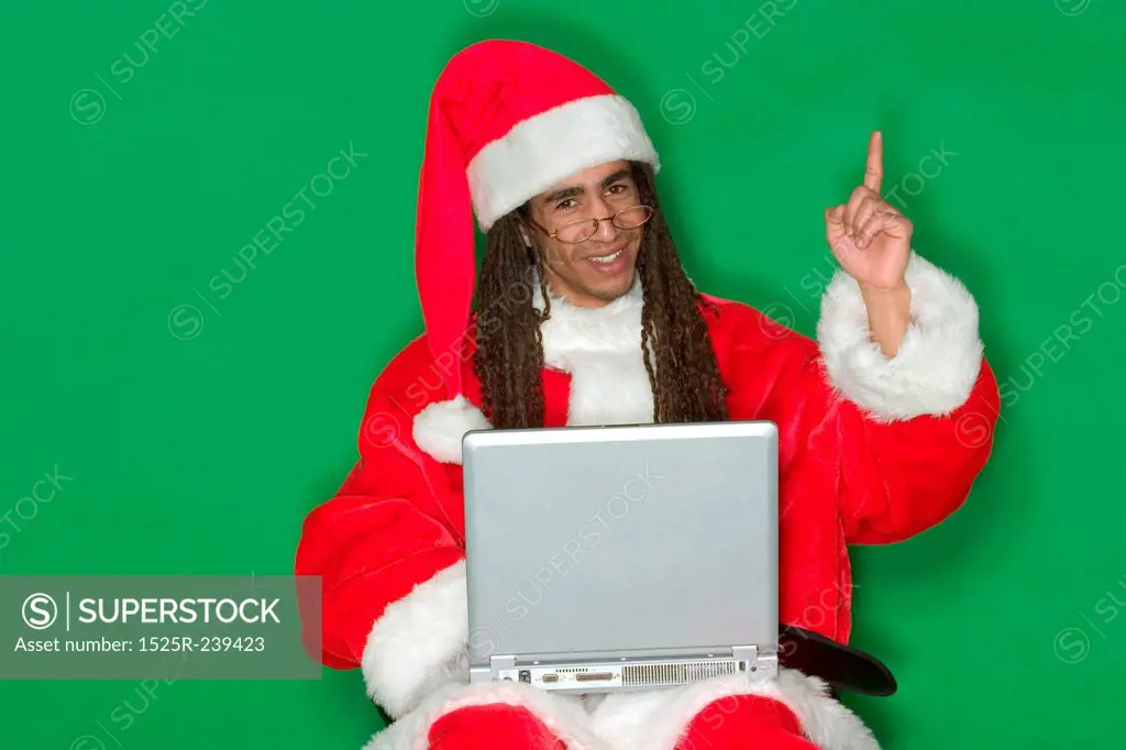 Happy Young Black Santa With Laptop