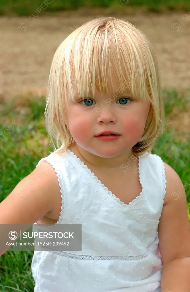 Blonde Little Girl in Grassy Field