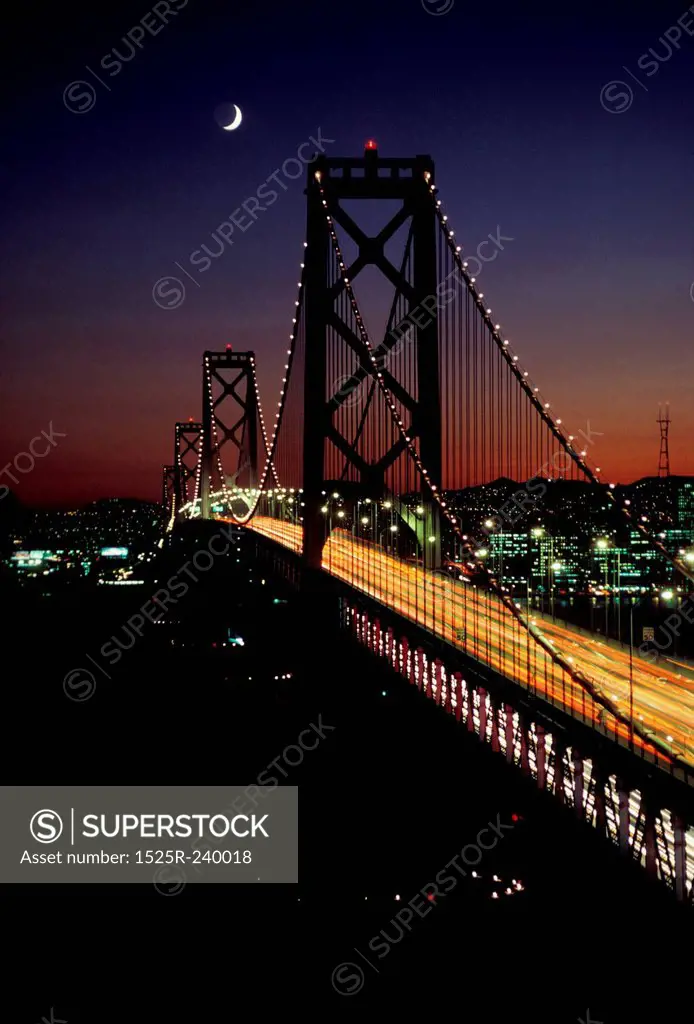 Suspension bridge at night with crescent moon and glowing urban cityscape in background