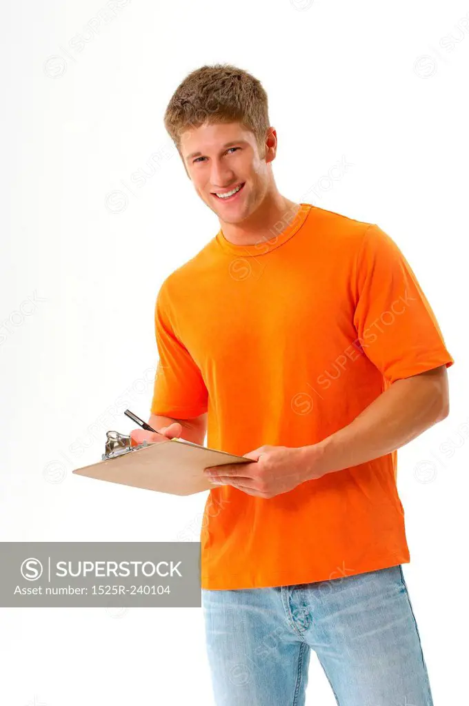 Confident man standing and writing on clipboard with paperwork