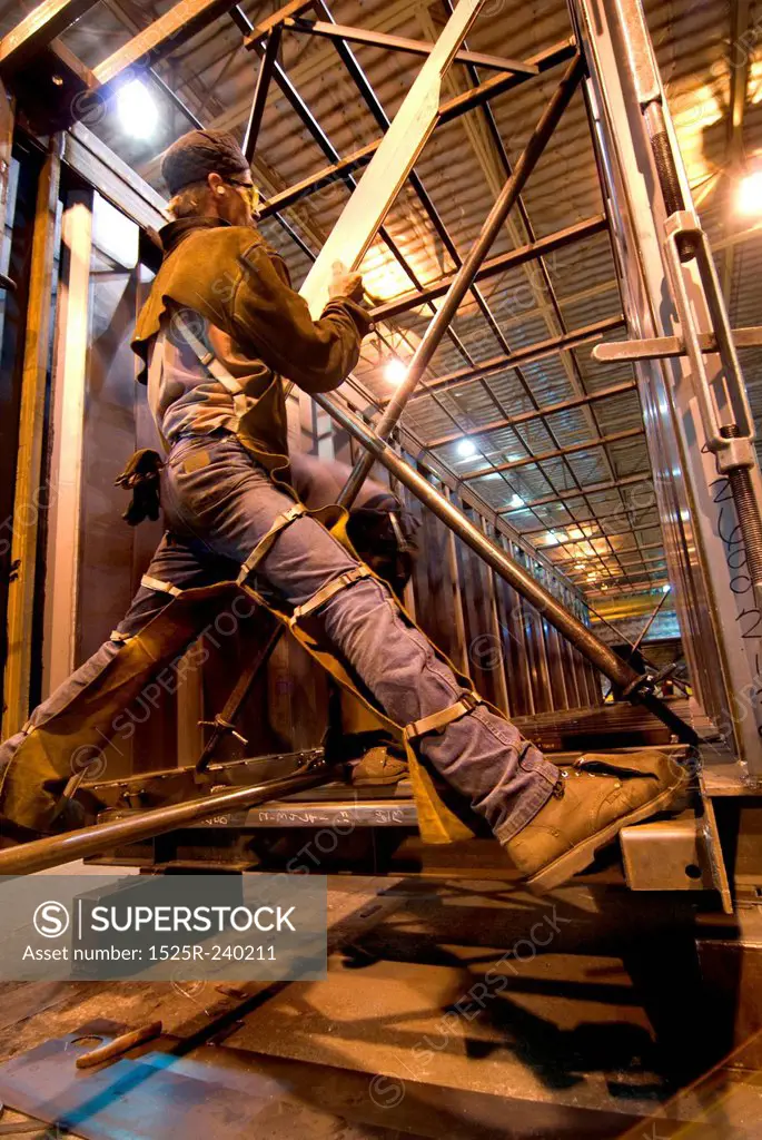 Construction worker on construction site balanced on girder using working on metal supports