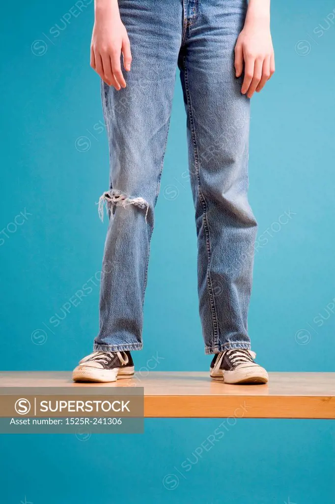 Legs of Teen Boy in Ripped Jeans