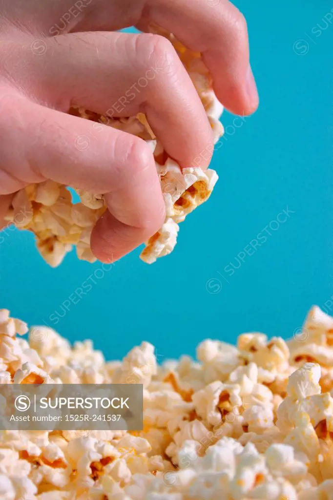 Hand Eating Popcorn
