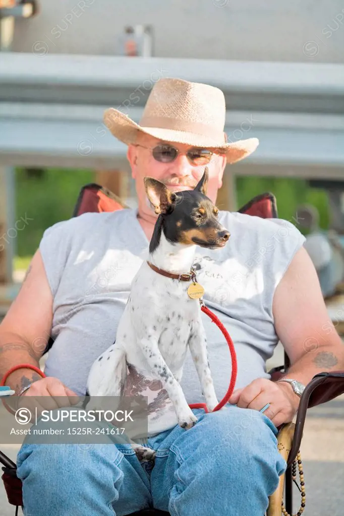 Man with Rat Terrier Sitting on Lap