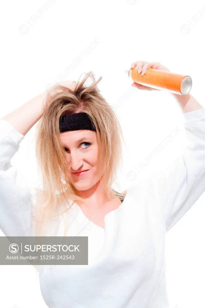 Attractive Young Woman Spraying Hairspray
