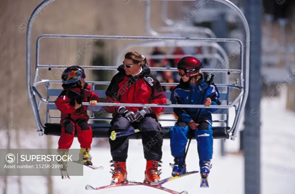 Couple with their daughter on a ski lift