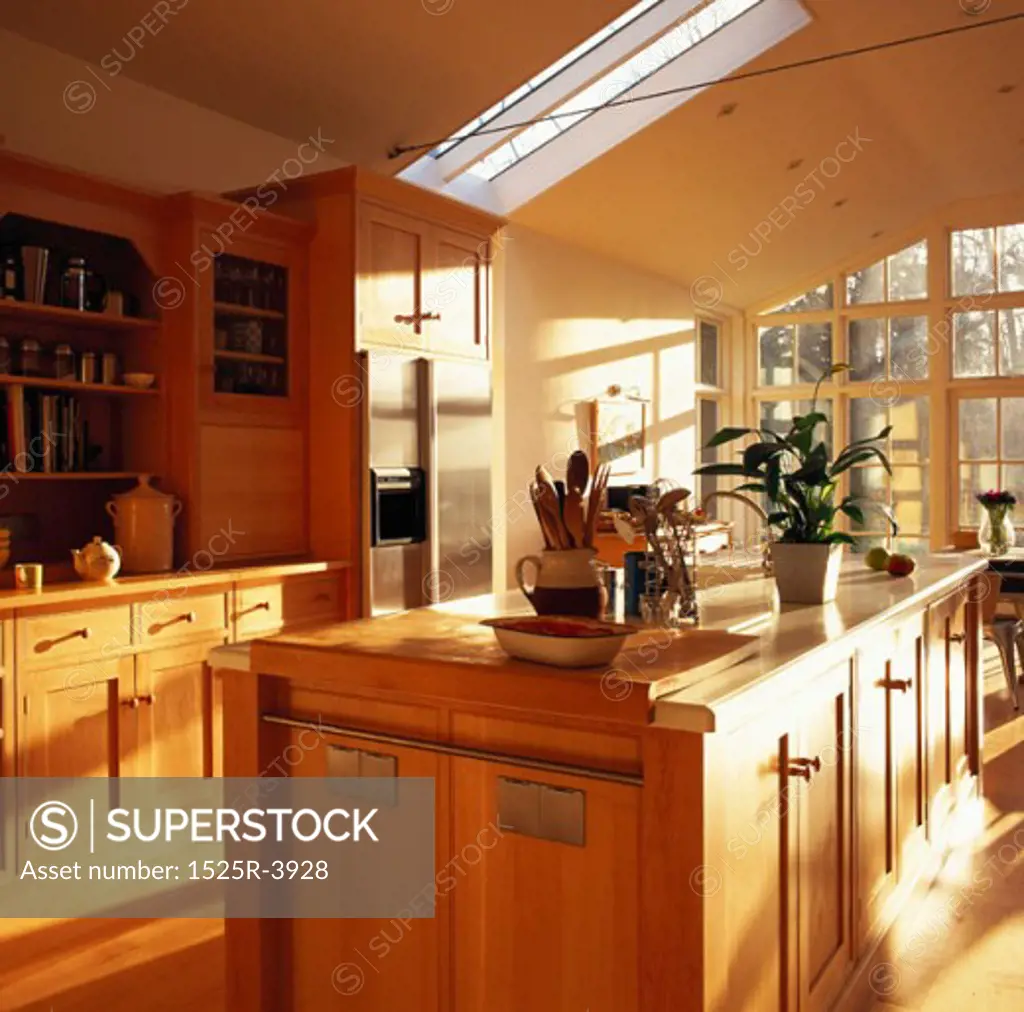 View of a wooden island counter in the center of a kitchen