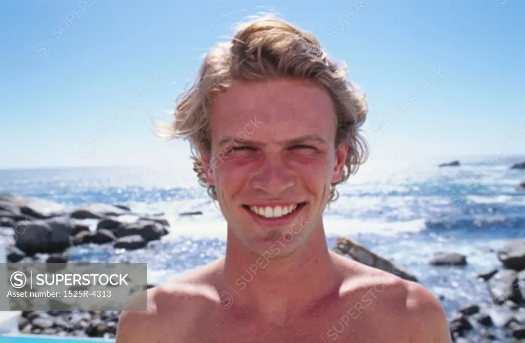 Portrait of a young man smiling on the beach