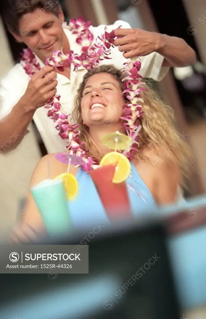 Man Putting Lei Over Woman's Head
