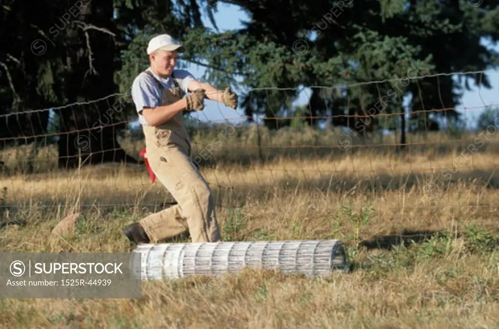 Young Man Laying Fence