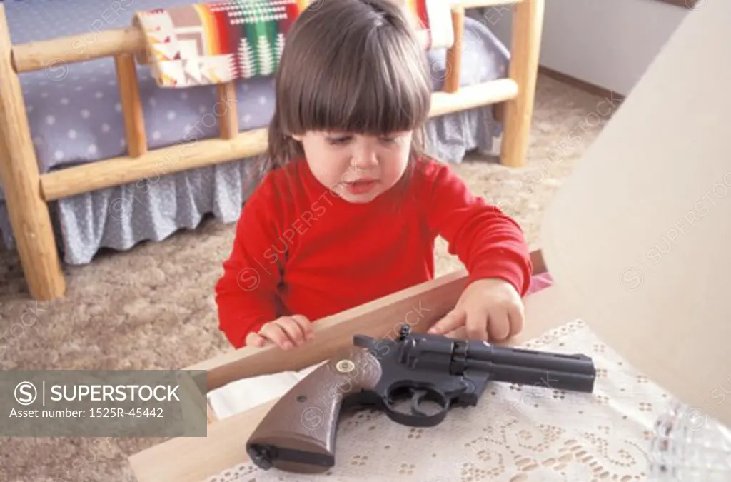 Little Girl Finding a Gun