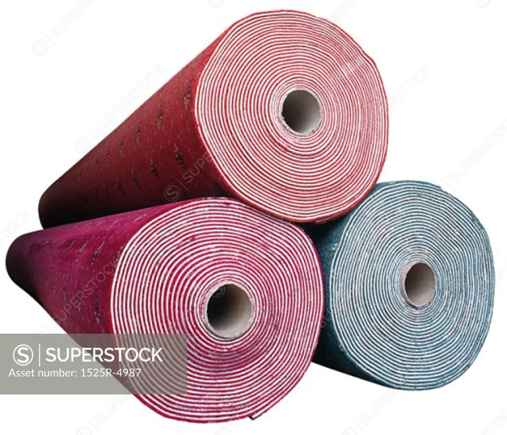 Photograph of 3 rolls of carpet.