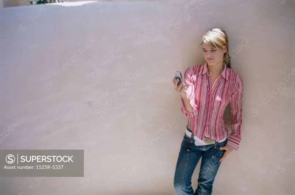 High angle view of a young woman holding a mobile phone