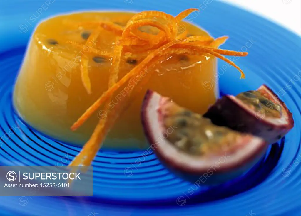 Close-up of a pudding with slices of passion fruit on a plate