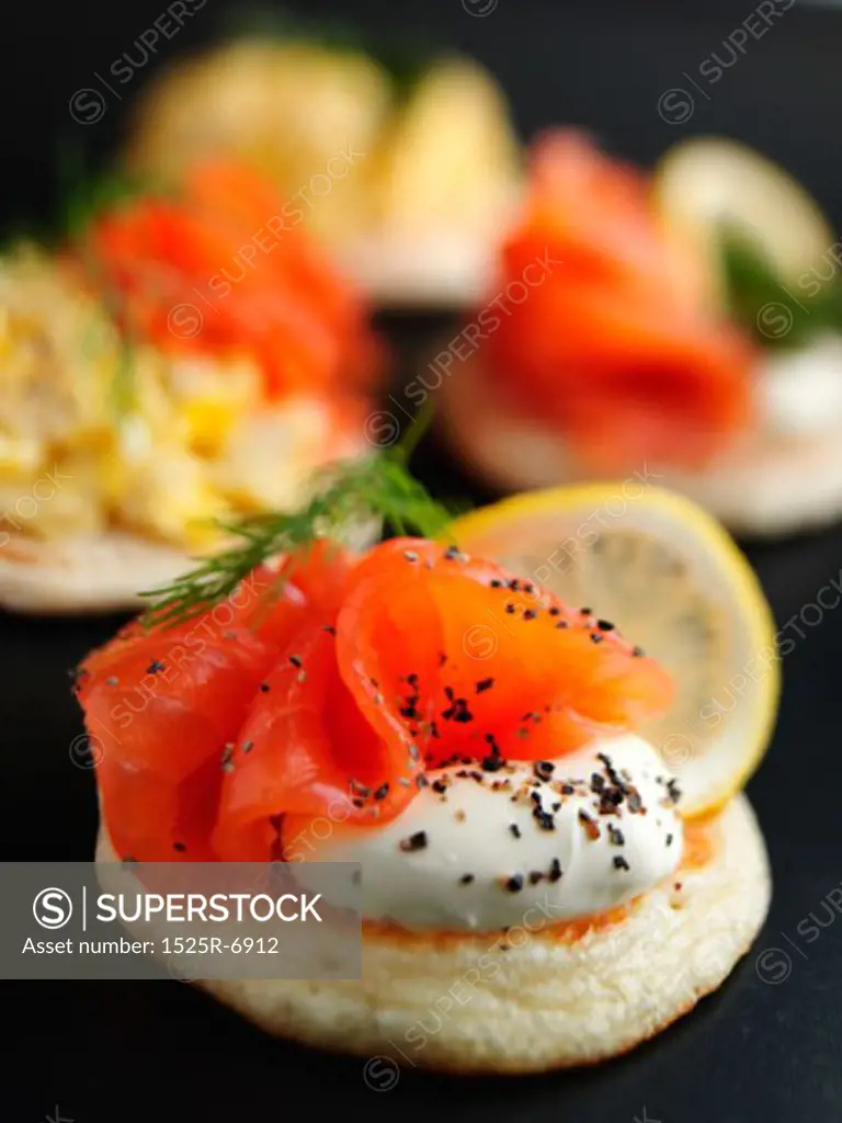 Close-up of blinis with smoked salmon and sour cream