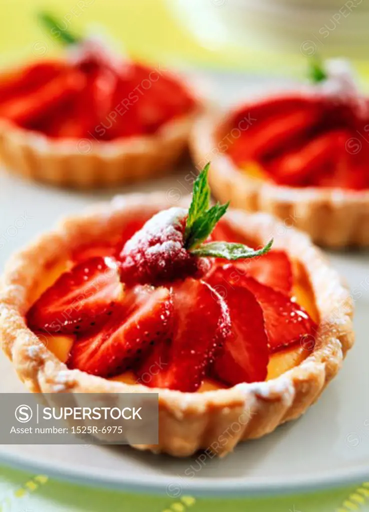Close-up of three strawberry tarts