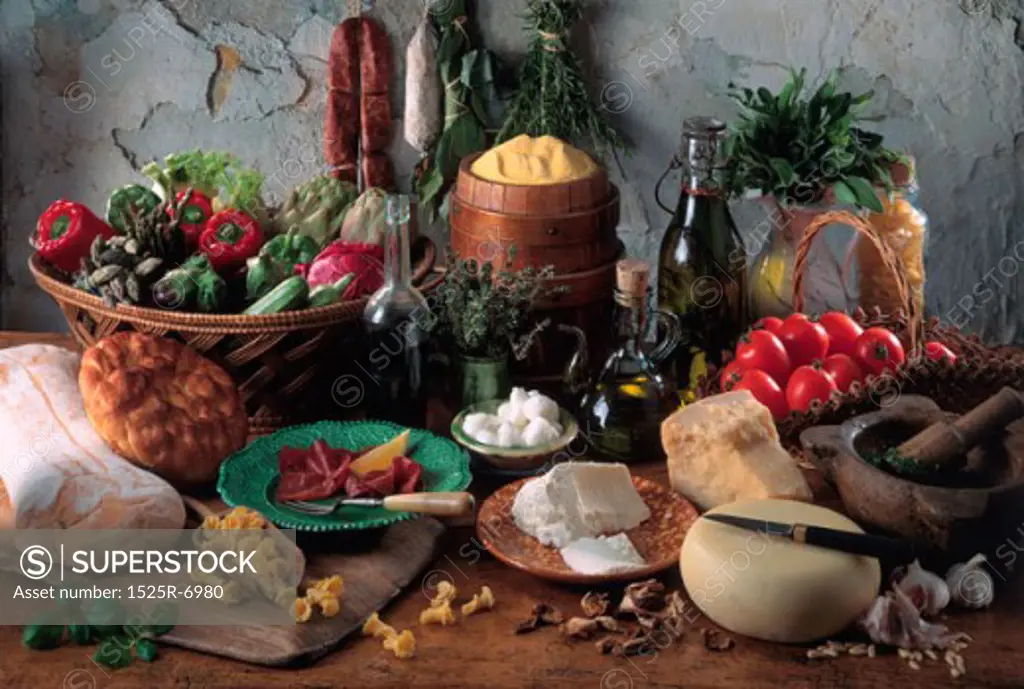 Close-up of assorted cheese with vegetables and a wine bottle on the table