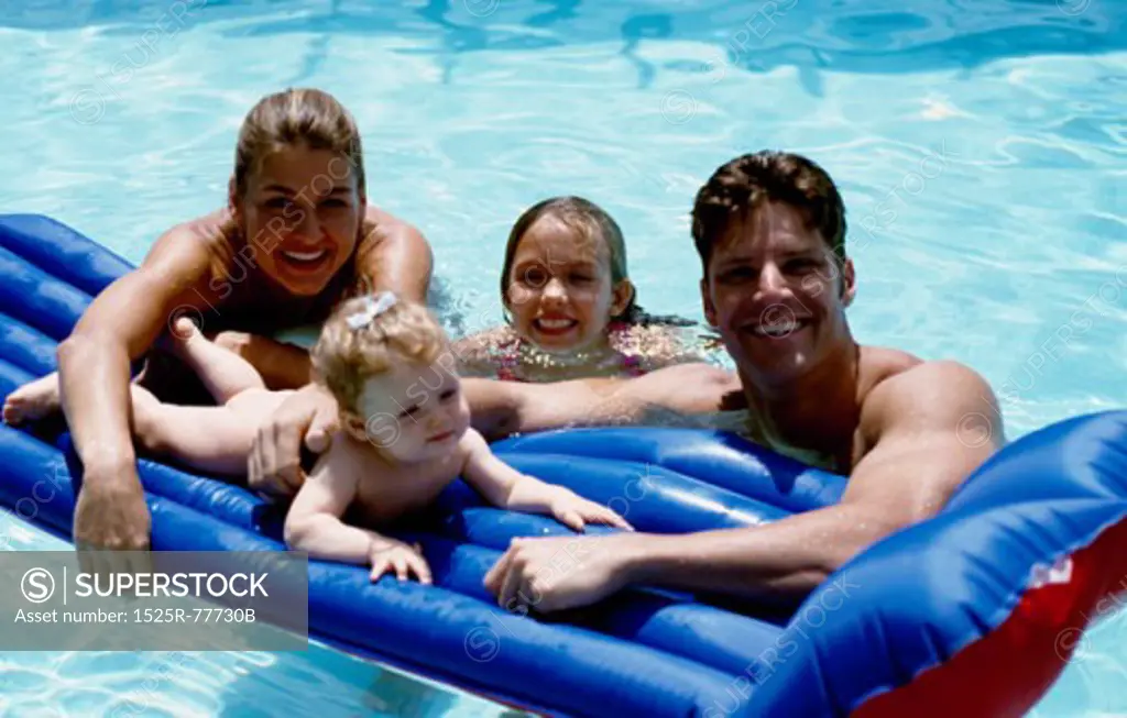 High angle view of parents with their two daughters in a swimming pool