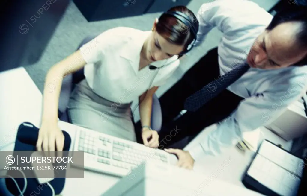 High angle view of a businesswoman and a businessman in an office