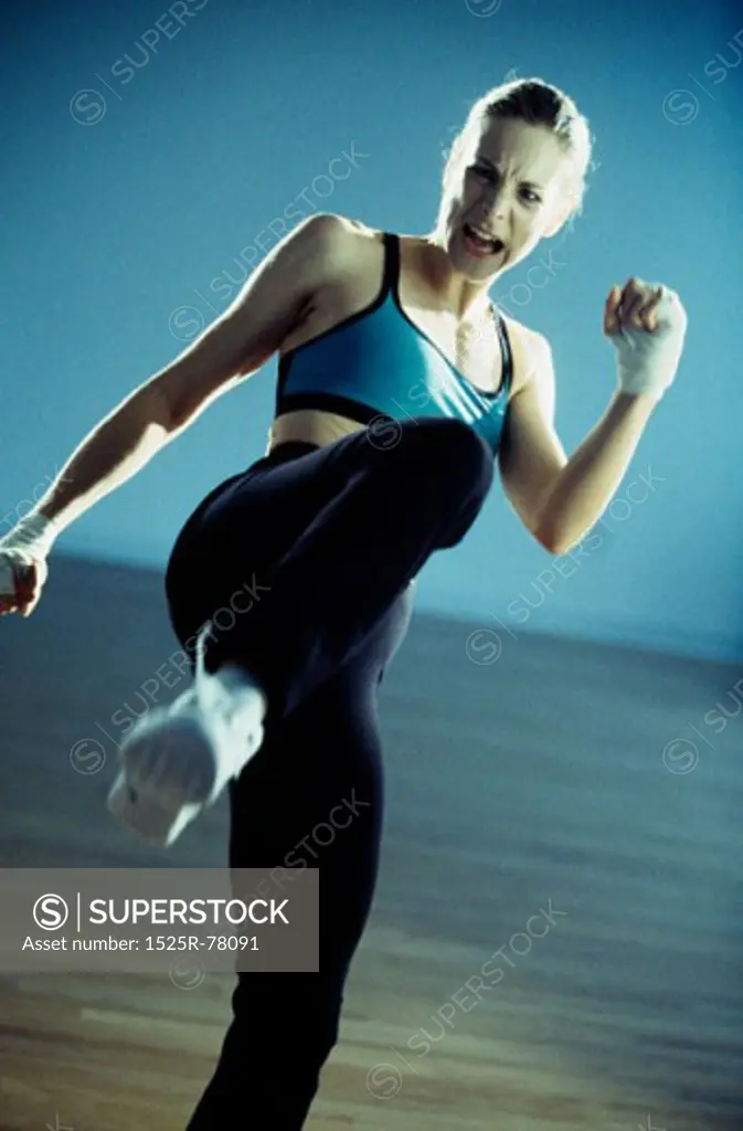 Close-up of a young woman kicking