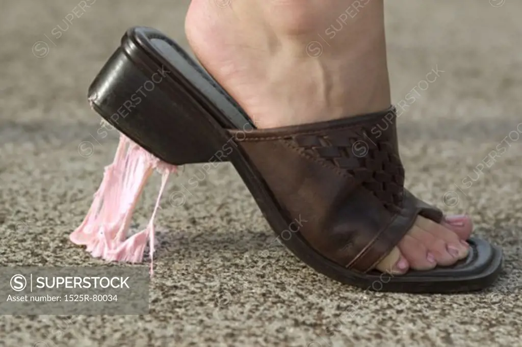 Bubble gum stuck under a woman's sandal
