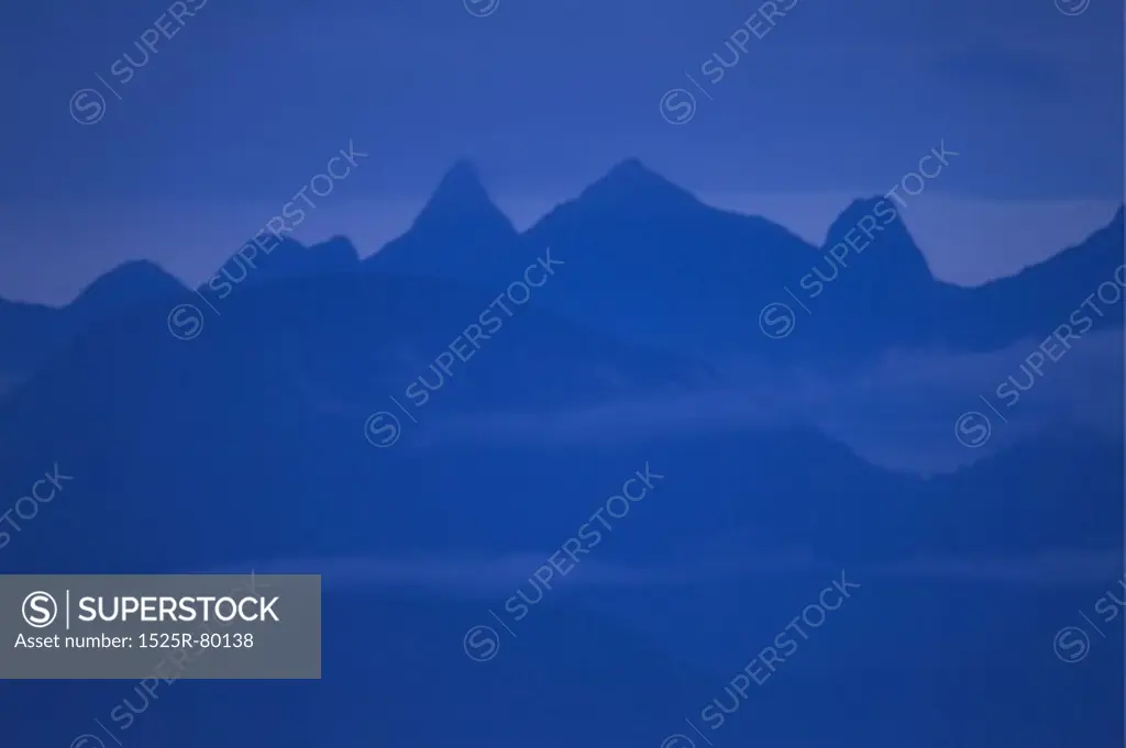 Silhouette of a mountain range at dusk