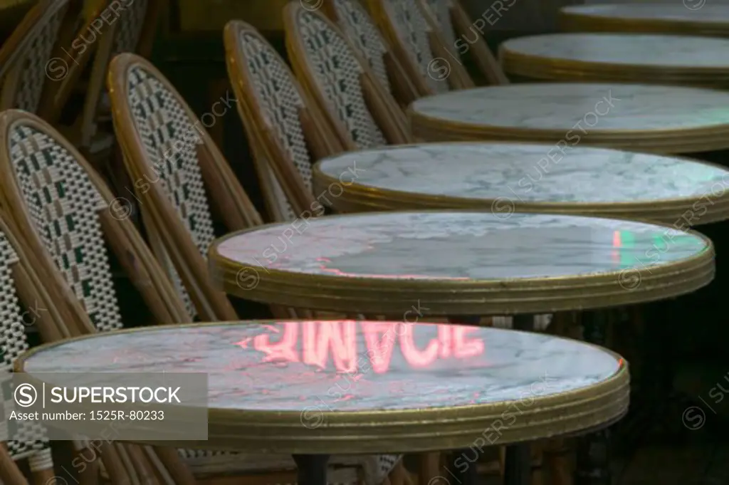 Close-up of tables and chairs in a row