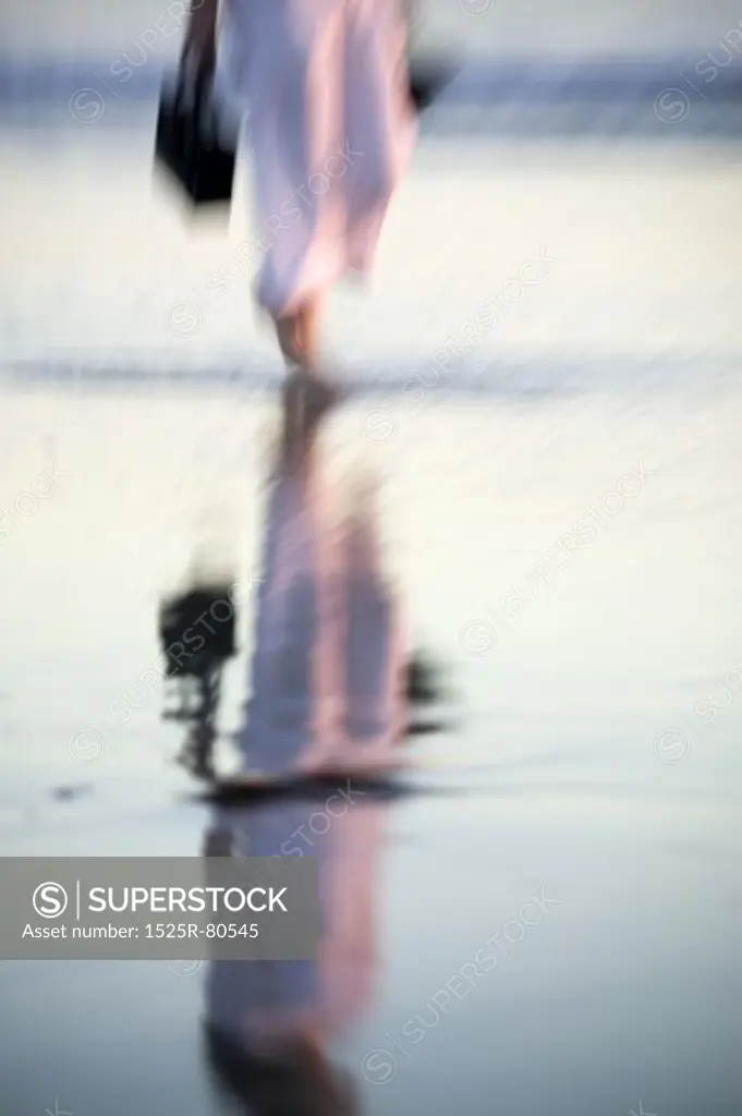 Reflection of a person wading in water