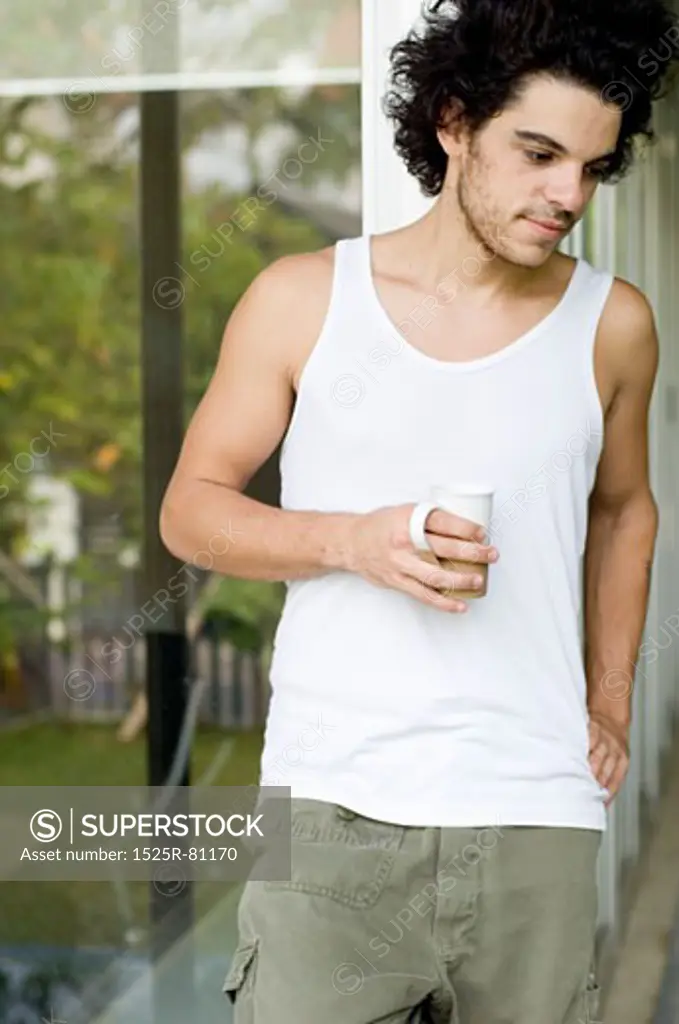 Close-up of a young man holding a cup of tea