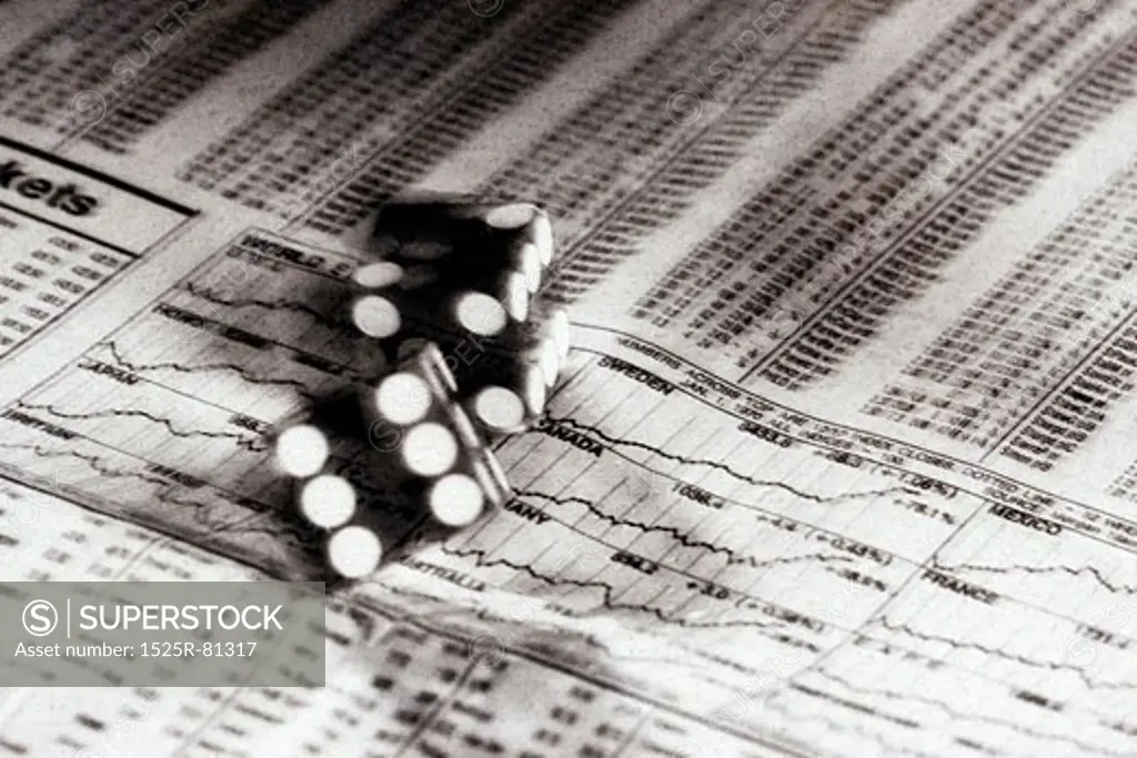 Close-up of a pair of dice on a stock market paper