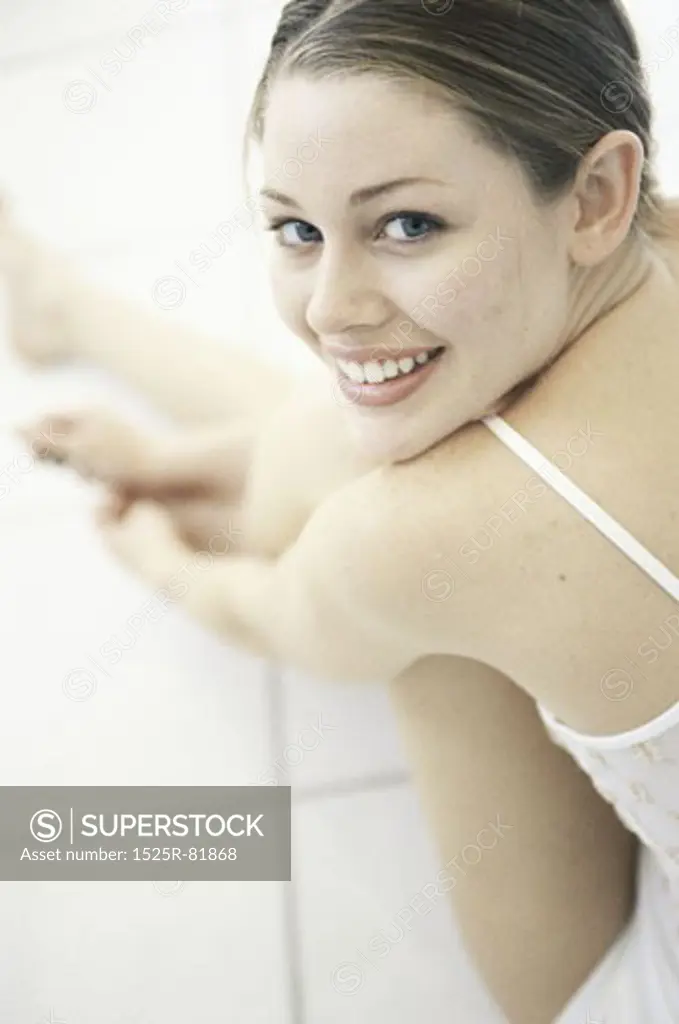 Portrait of a young woman sitting on the floor