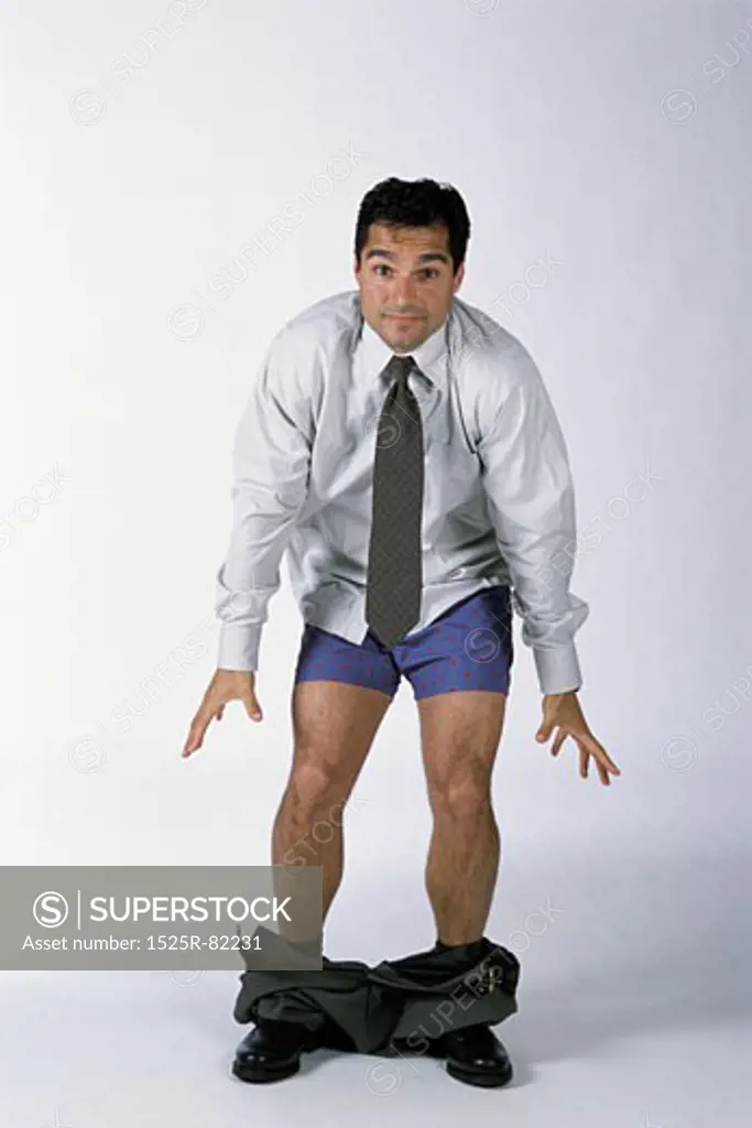 Portrait of a businessman standing with his pants down