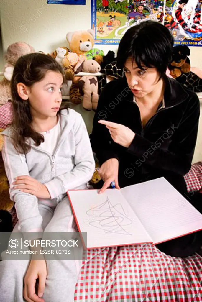 Mid adult woman scolding her daughter