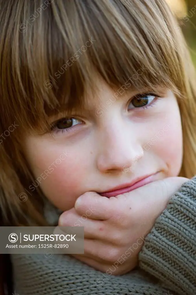 Close-up of a girl with her hand on her chin