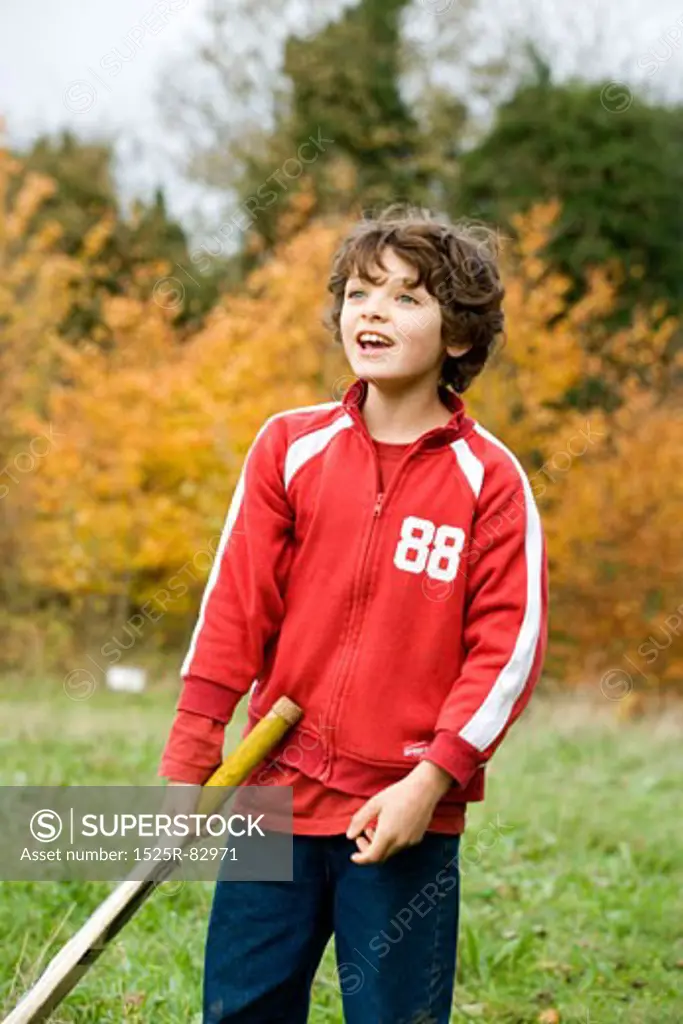 Boy holding a cricket bat and smiling