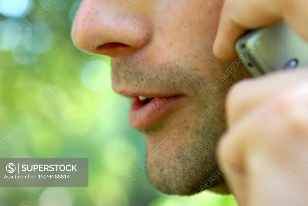 Close-up of a man talking on a mobile phone