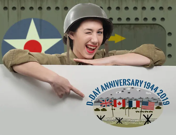 a young woman dressed in wwii military uniform with helmet showing signboard with 75 th of D-Day anniversary